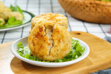 Delicious Fried Eggplant Cutlet with Golden Crispy Coating on Fresh Lettuce Leaves © LyVan