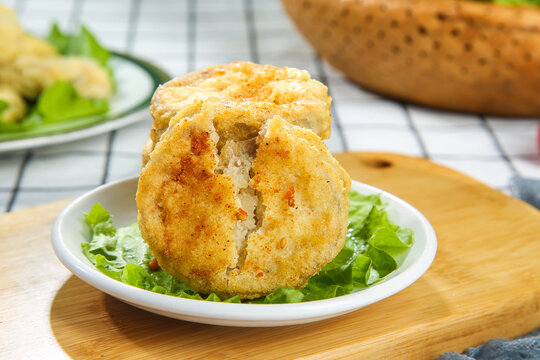 Delicious Fried Eggplant Cutlet with Golden Crispy Coating on Fresh Lettuce Leaves
