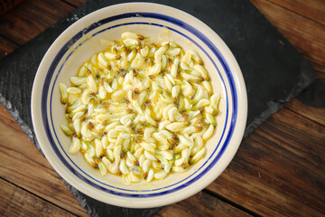 Fresh Pasta with Herbs in Ceramic Bowl on Wooden Table