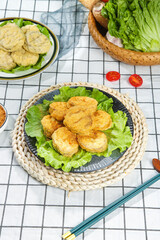 Delicious Deep Fried Eggplant Cakes with Fresh Vegetables and Chopsticks on Kitchen Table