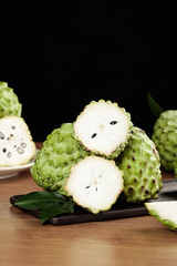 Fresh Custard Apple Sugar Apple Fruit with White Flesh and Seeds on Wooden Table