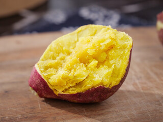 Fresh Roasted Sweet Potato with Golden Yellow Flesh on Wooden Board