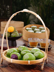 Traditional Handmade Green Tea Dumplings in Bamboo Steamers with Asian Tea Service