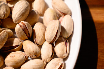 pistachio nuts on wooden table