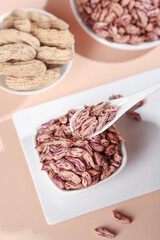 Colorful Dried Beans and Peanuts in White Bowls - Healthy Natural Protein Foods Display
