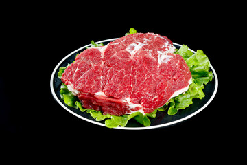 Raw Beef Brisket Cuts on Plate with Lettuce Garnish Ready for Cooking