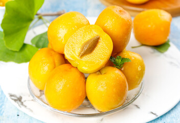 Fresh Ripe Yellow Apricots on Glass Plate with Green Leaves - Naturally Ripened Stone Fruits