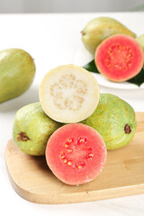 Fresh White and Red Guavas with Soft Cream Center on Wooden Board