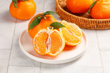 Fresh Orange Slices with Leaves on Plate and Wicker Basket Kitchen Setup