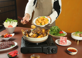 Asian Hot Pot Cooking with Chopsticks and Fresh Ingredients Traditional Stew Preparation