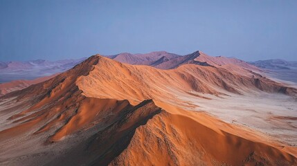 Fototapeta premium Giant sand dunes under golden hour light, dramatic lines and shadows, untouched terrain, abstract natural beauty 