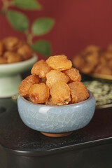 Dried Longan Fruits in Ceramic Bowl - Traditional Chinese Preserved Fruit Snack