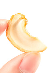 Crispy Salt-Baked Vietnamese Cashew Nut Kernel Held in Hand on White Background