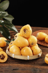 Fresh Yunnan Loquat Fruits in Bamboo Basket on Wooden Table - Asian Mountain Fruit Display