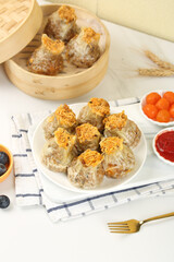 Gourmet Siu Mai Dim Sum with Salted Egg Yolk and Meat Puff Topping in Bamboo Steamer