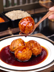 Braised Lion's Head Meatballs in Sauce - Traditional Chinese Banquet Dish on White Plate