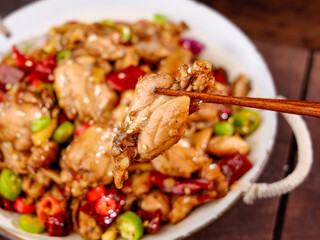 Spicy Chicken Stir Fry with Fresh Peppers and Vegetables in Bowl with Chopsticks