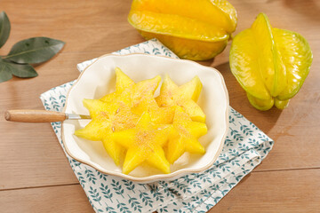 Star Fruit Slices in Bowl - Fresh Tropical Asian Fruit Display on Wooden Table