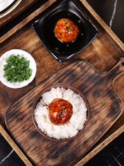 Braised Lions Head Meatball Specialty Dish with Rice and Scallions on Wooden Serving Tray