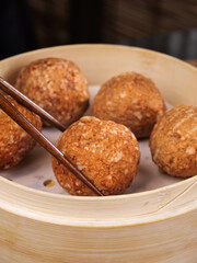Braised Lions Head Meatballs in Bamboo Steamer with Chopsticks Asian Specialty Cuisine