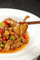 Spicy Asian Stir-Fry with Meat and Vegetables in White Bowl with Chopsticks