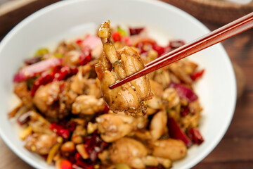 Spicy Asian Stir-Fry with Meat and Vegetables in Chopsticks - Traditional Chinese Cuisine