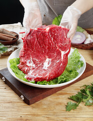 Fresh Raw Beef Steaks Presented by Chef with Gloves on Cutting Board - Premium Meat Preparation