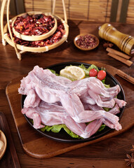 Fresh Raw Chicken Wings with Spices and Vegetables on Rustic Wooden Table