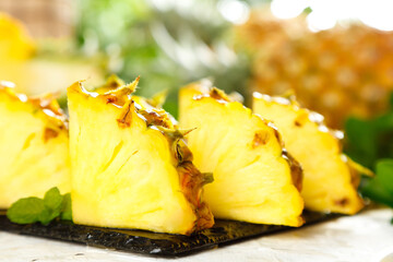 Fresh Pineapple Slices Cut and Arranged on Dark Slate Board with Natural Lighting