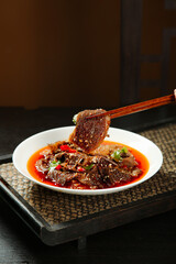 Spicy Red Tripe in Chili Oil Sauce with Chopsticks - Traditional Chinese Hot Pot Cuisine