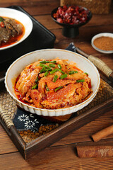 Spicy Red Oil Braised Tripe Traditional Asian Cuisine Dish with Green Onion Garnish on Wooden Table