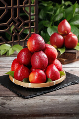 Fresh Red Nectarines in Bamboo Basket with Water Droplets on Rustic Wooden Table