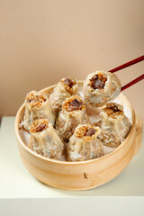 Traditional Siu Mai Dim Sum Dumplings with Pork and Shiitake Mushrooms in Bamboo Steamer