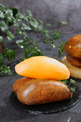 Fresh Yellow Highland Potatoes from Yunnan China with Herbs on Dark Slate Background