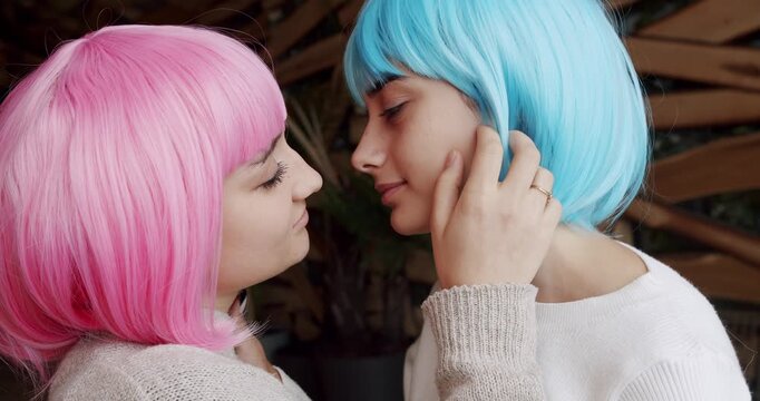 Embrace and holding each other. Love and kiss, Pride Event, friendship concept. Romance and portrait of lesbian couple with blue and pink hair enjoying. LGBT rights, Lesbian family.