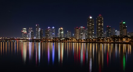 Fototapeta premium Night Cityscape Reflection Over Water with Vibrant Lights