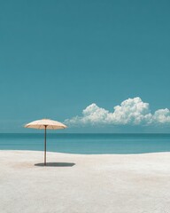 Fototapeta premium Solitary beige beach umbrella on pristine white sand, tranquil turquoise ocean and clear blue sky with fluffy clouds