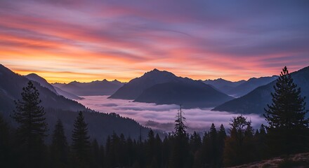 Obraz premium Scenic mountain landscape at sunrise with colorful sky and fog