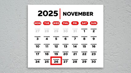 The date November 26th marked with a red cursor on the wall calendar 2025