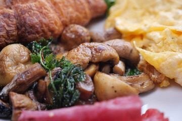 Delicious breakfast featuring mushrooms and croissant