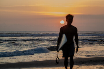 Silhouette of a surfer on the beach