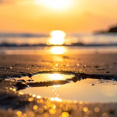 Sunset reflected in a puddle on a sandy beach