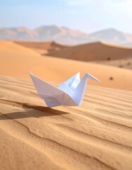 Paper crane rests in desert. Sand dunes stretch far