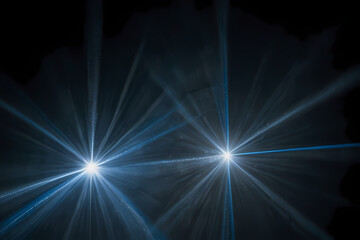 White and blue laser beams shining in a dark fog.