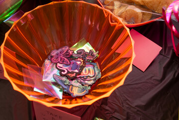 Party favors in plastic orange bowl of stickers at kid's birthday party