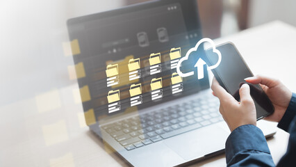 Hands holding smartphone with laptop in background, showing digital cloud upload icon and file folders, representing online data backup, export, and secure personal record storage.