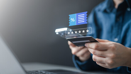Hands holding credit card and smartphone with digital promo code and discount voucher icon, representing online shopping checkout, secure ecommerce payment, and digital sale offers.