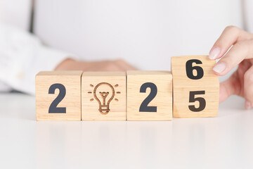 2025 year change to 2026 year block with lightbulb. Business Idea, Creative, Thinking, brainstorm, Goal, Resolution, strategy, plan, Action, change and New Year start concepts