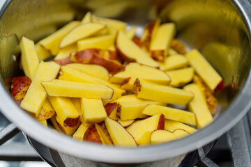 Chopped raw fresh potatoes preparing rustic meal