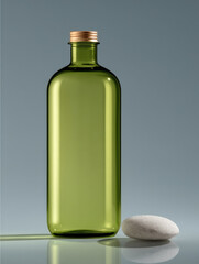 Green glass bottle with gold cap, minimal design, standing beside smooth stone on gray background, modern and calm atmosphere